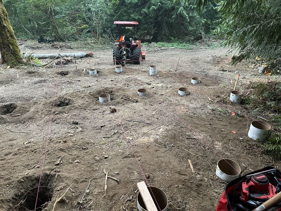 Post hole drilling with tractor and auger